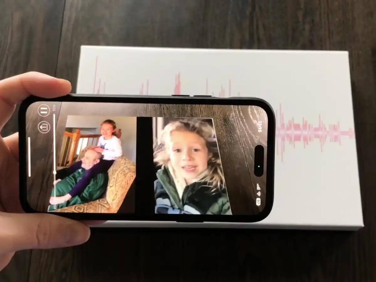 A phone using the Soundwave Art app to play a video connected to a photograph